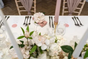 Table setting with pink floral napkin decor at the Pelham House photoshoot.