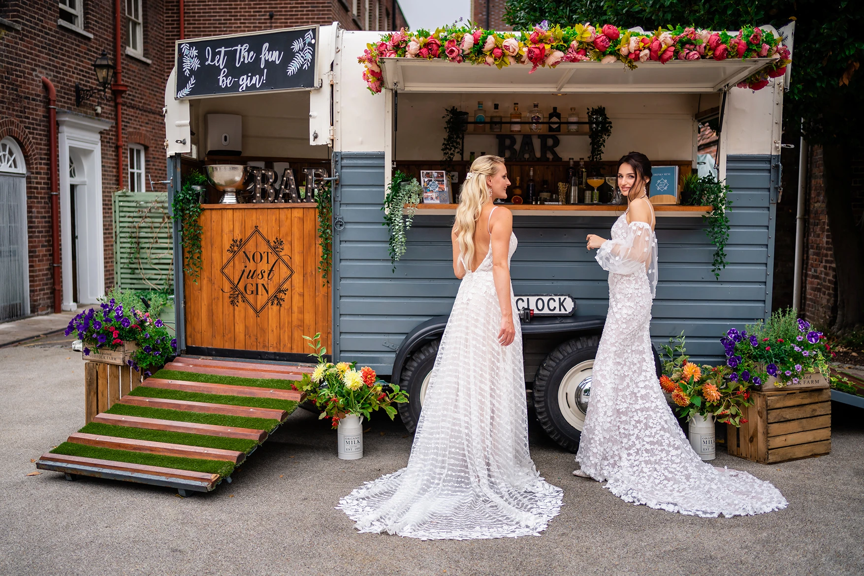 Bridal duo posing with a vintage bar at Pelham House photoshoot