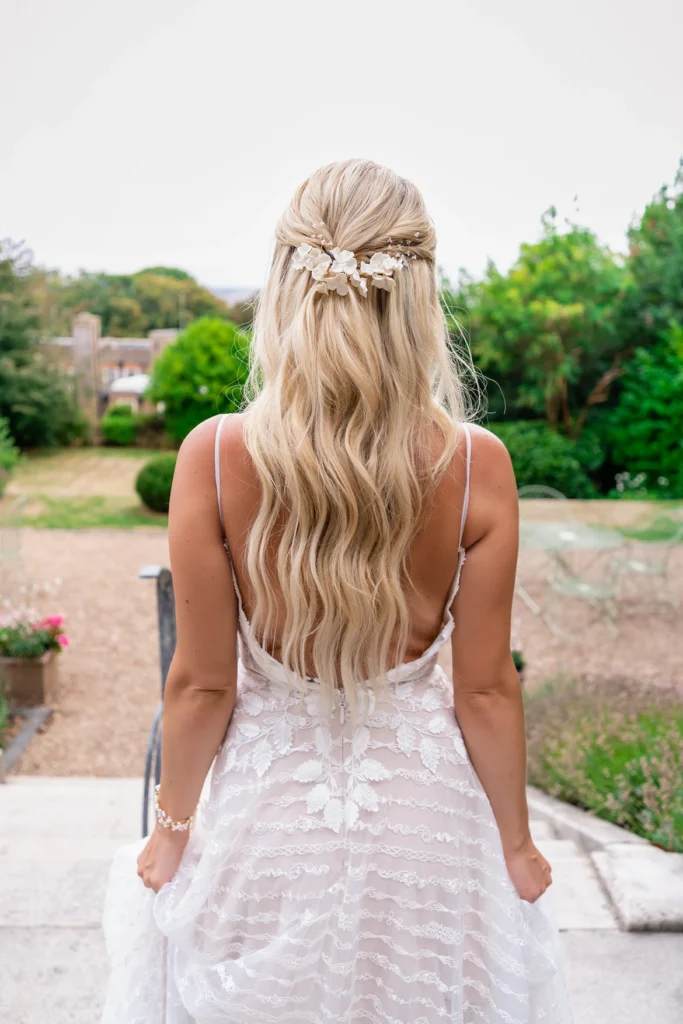 Back view of bride with floral hairpiece at Pelham House garden