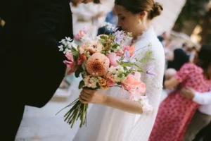 Bride holding a vibrant floral bouquet at her minimalist London wedding.