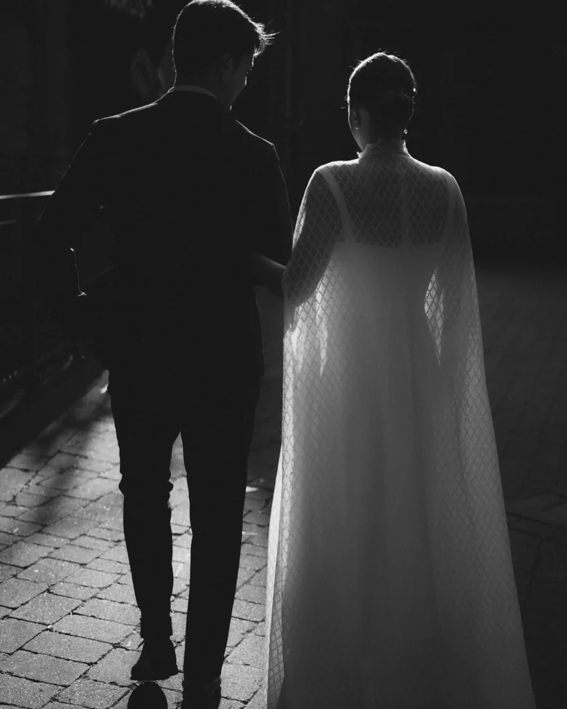 Silhouette of the bride and groom walking together in the evening after their minimalist wedding in London.