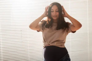 Pregnant woman enjoying music with headphones