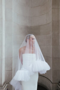 Bride posing with a modern veil design