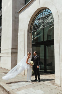 Bride and groom standing outside a chic wedding venue