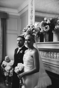 Newlyweds posing inside an chic wedding venue