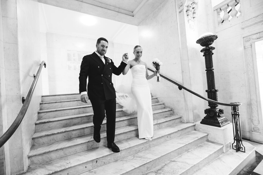 Bride and groom walking down a staircase