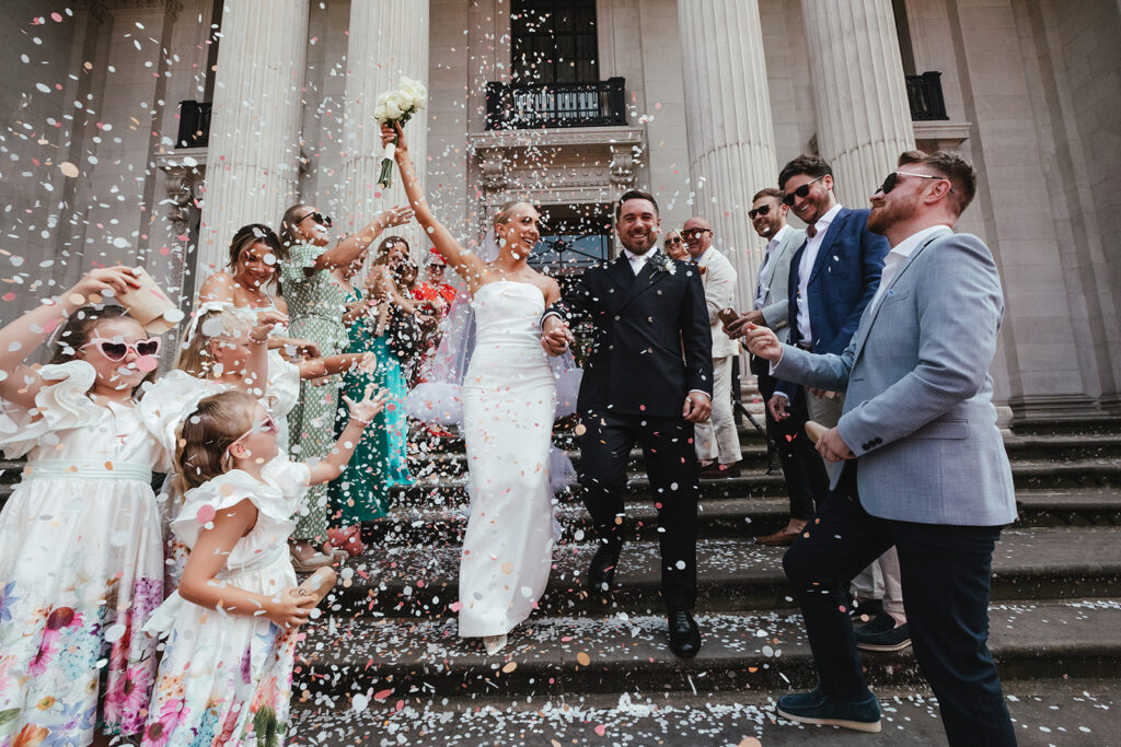 Newlyweds showered in confetti on chic wedding steps