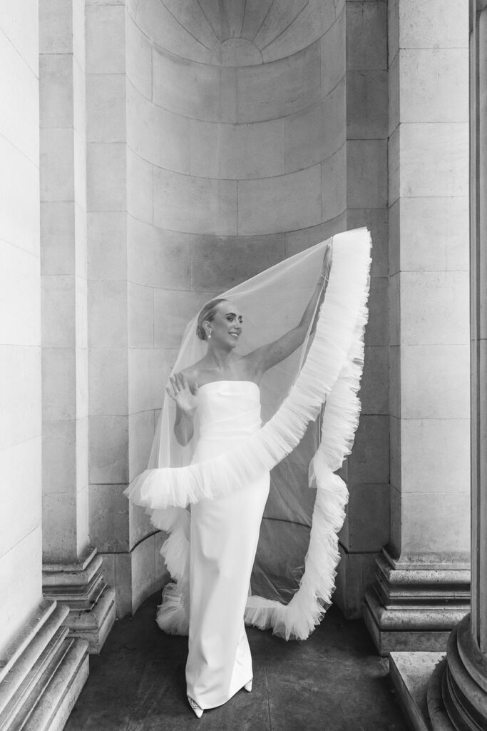 Bride posing with a dramatic tulle veil