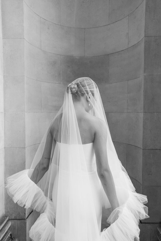 Bride showing her elegant hairstyle under a tulle veil