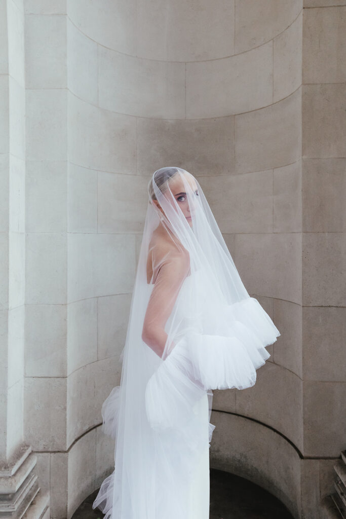 Bride with a contemporary tulle veil in a city chic wedding setting