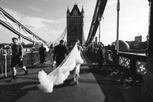 Bride and groom crossing the iconic Tower Bridge