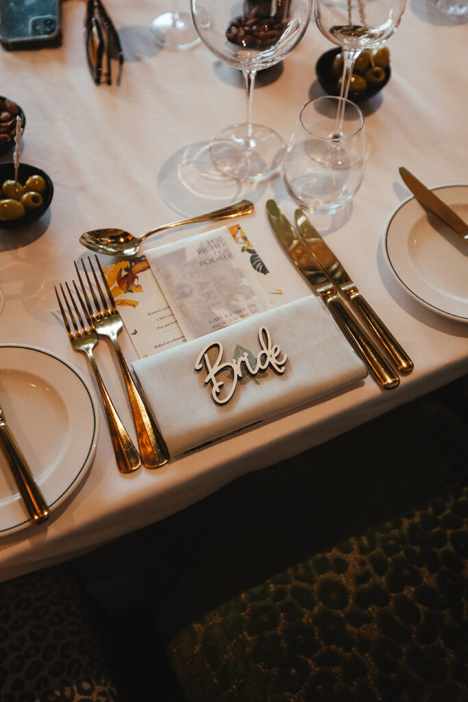 Luxurious bride table setting with gold cutlery and ‘Bride’ name tag