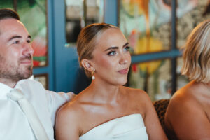 Bride getting emotional while listening to a heartfelt speech at the reception