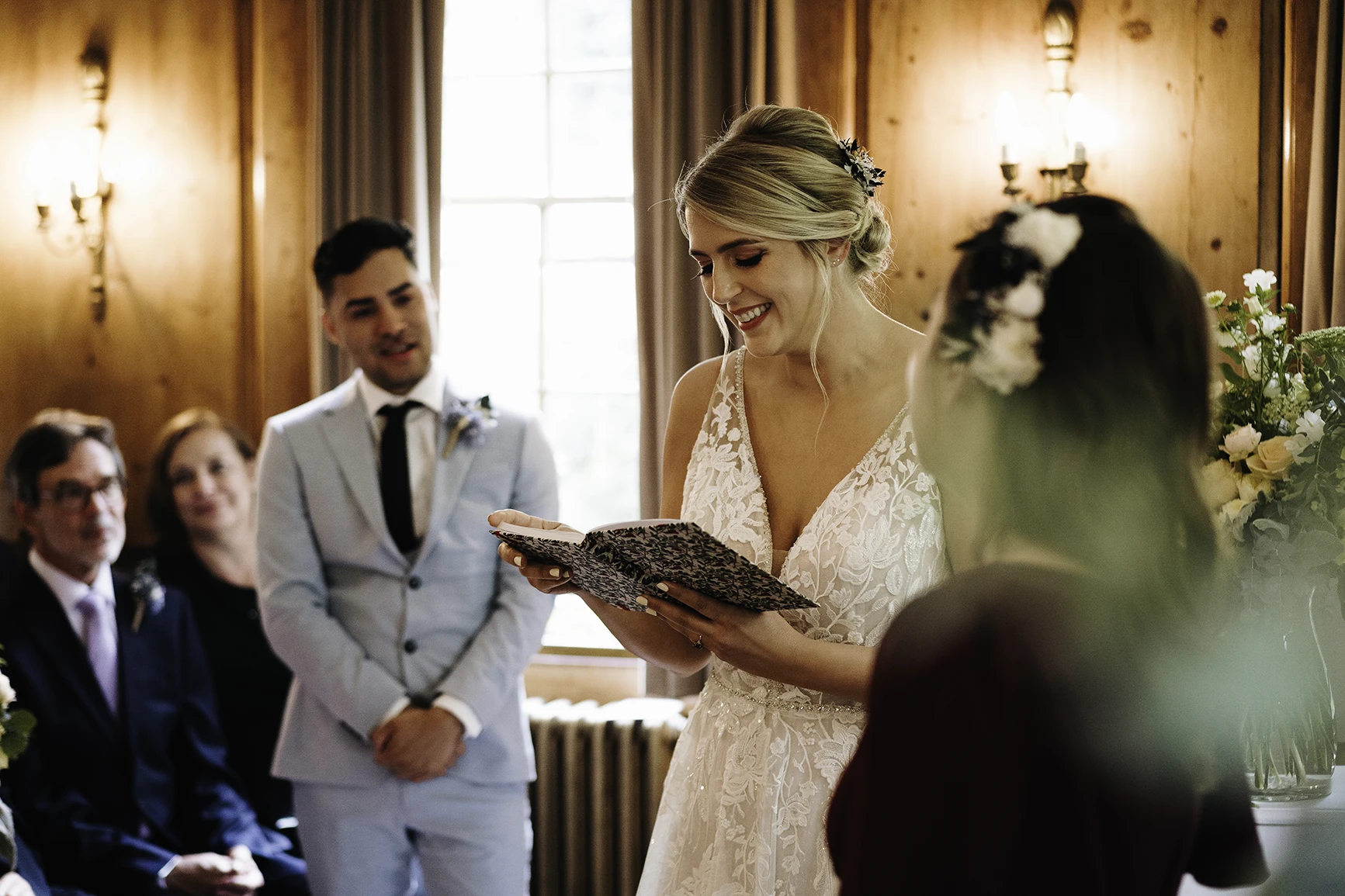 Bride smiling while reading her vows during Burgh House wedding