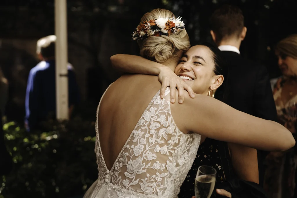 Bride warmly embracing a guest