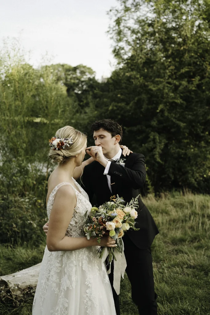 Groom delicately adjusts the bride's hair