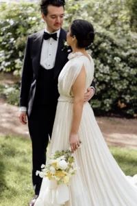 Elegant wedding couple sharing a moment in a lush garden setting