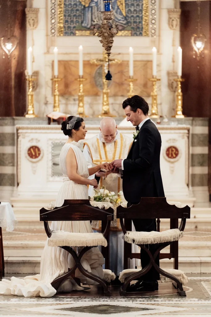 Groom placing a wedding ring on bride’s finger in an elegant ceremony