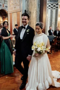 Newlyweds walking down the aisle with joy after their elegant wedding