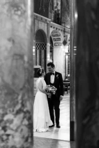 Elegant wedding couple sharing an intimate moment inside a grand cathedral