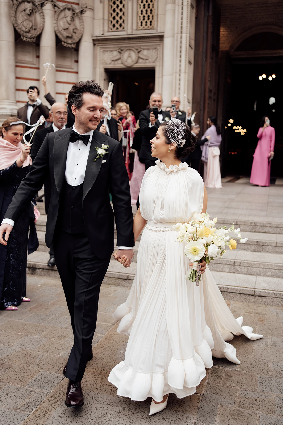 Just married couple walking hand in hand, looking at each other with joy