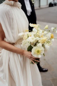 A close-up of the bride’s delicate floral bouquet with soft pastel tones