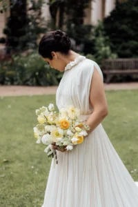 Bride with soft updo and pearl accents in the garden