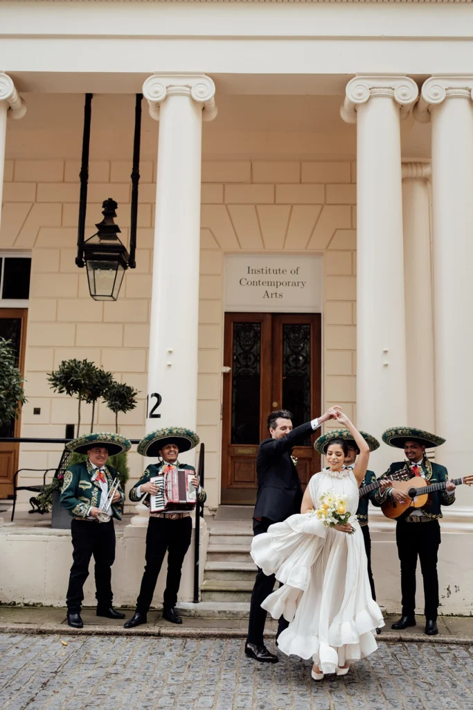 Bride and groom twirling joyfully with a live mariachi band