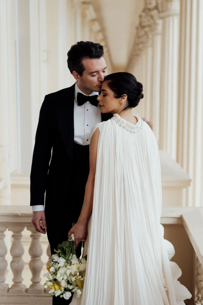 Bride and groom share a romantic moment at their elegant wedding