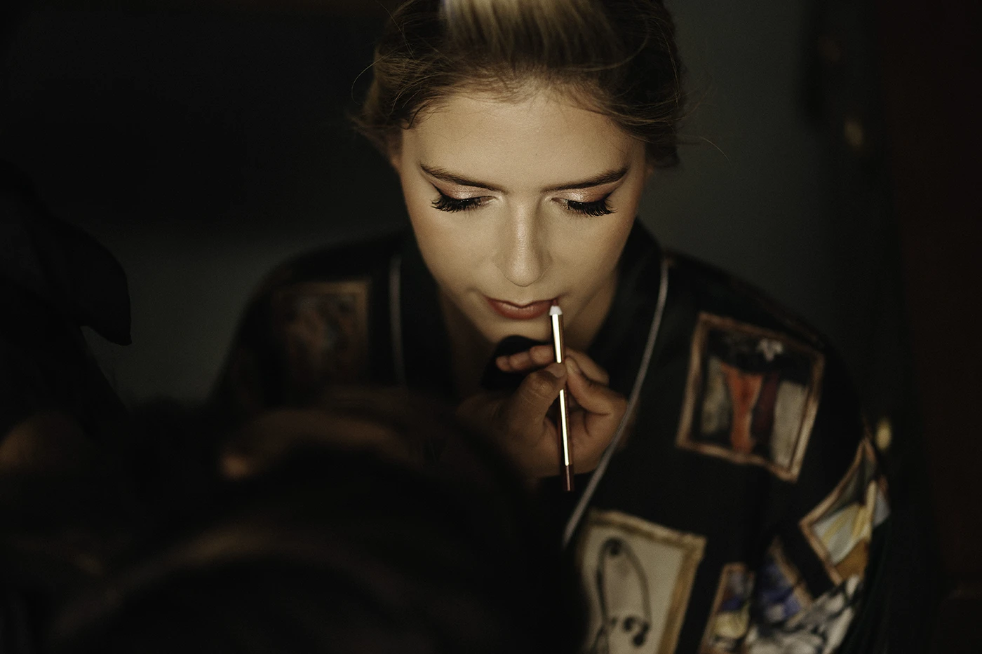 Bride getting her lips done during a professional makeup trial