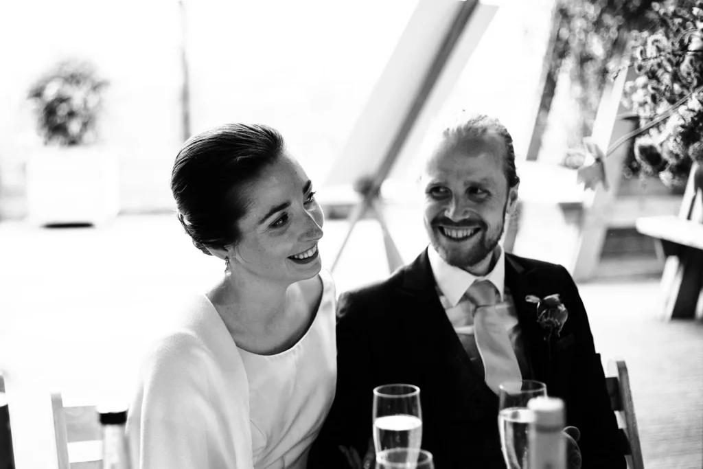 Bride and groom enjoying a relaxed wedding moment indoors