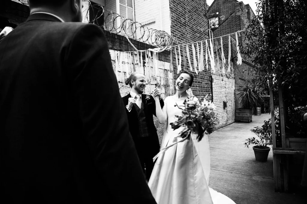 Newlyweds celebrating with guests in a rustic wedding setting