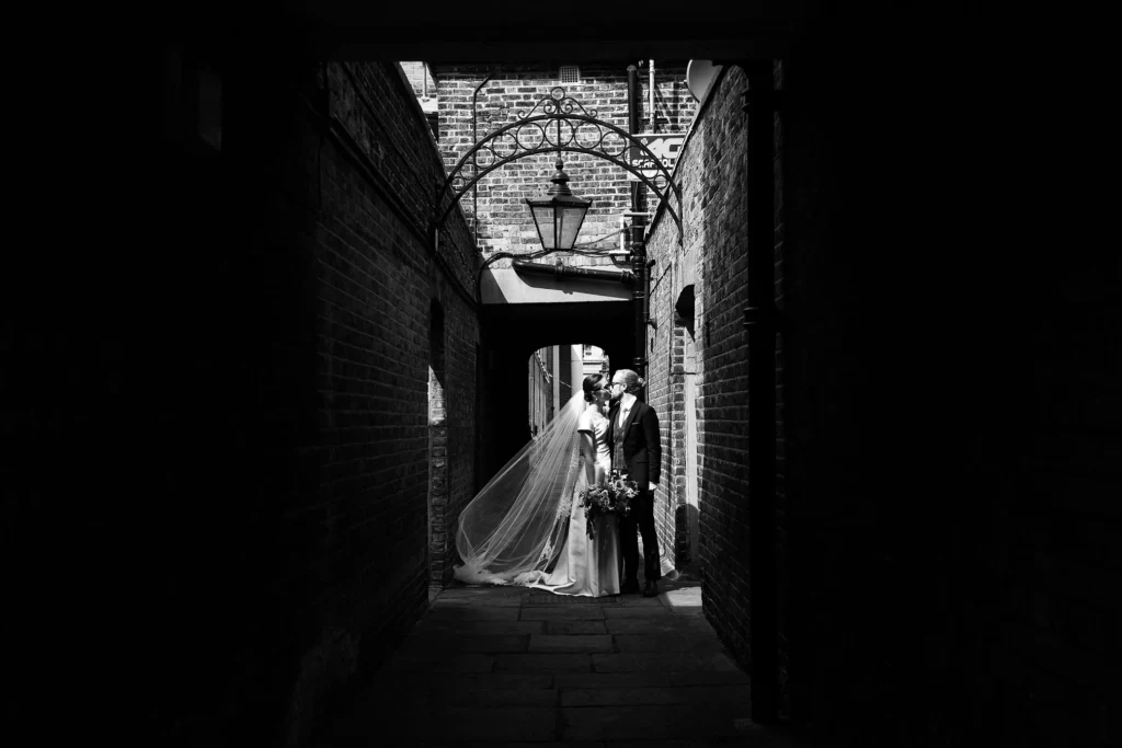 Romantic black and white wedding portrait in a London alleyway