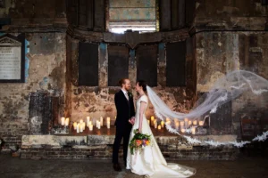 Bride and groom posing in a candlelit setting