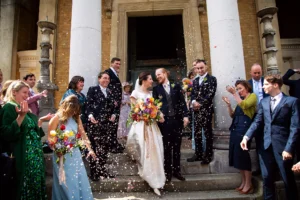 Bride and groom sharing a loving look as confetti falls outside