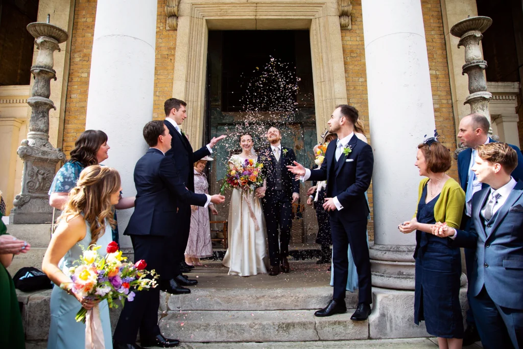 Guests showering the newlyweds with confetti