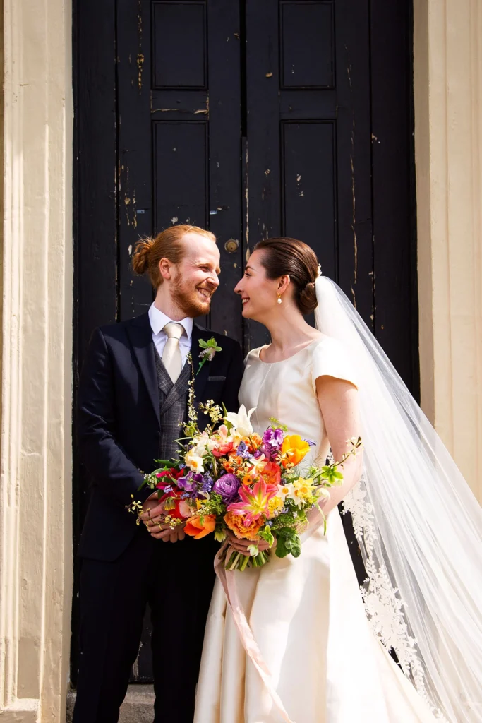 Bride and groom smiling at each other