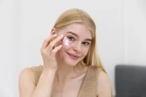 Woman using pink under-eye patches to refresh her skin before her wedding day