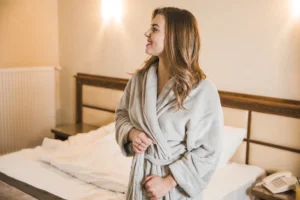 Bride-to-be embracing a peaceful morning in a robe before her wedding week begins