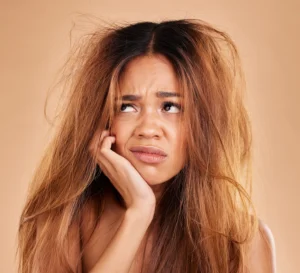Woman struggling with dry and frizzy hair before treatment at salon