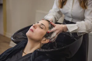 Relaxing scalp massage during frizzy hair salon treatment in London