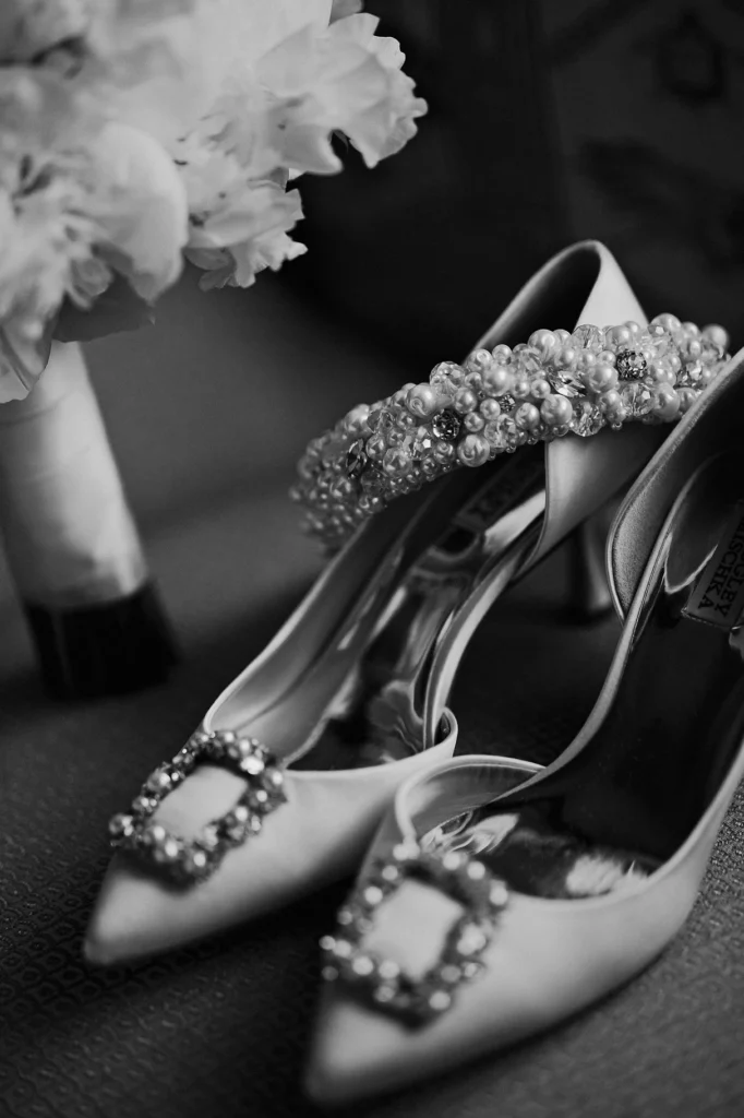 Close-up of satin bridal shoes and pearl headband