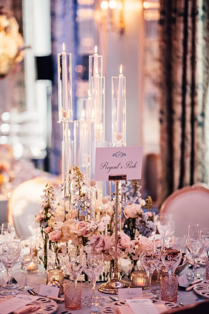 Luxury wedding reception table with floral centrepieces and tall candle holders
