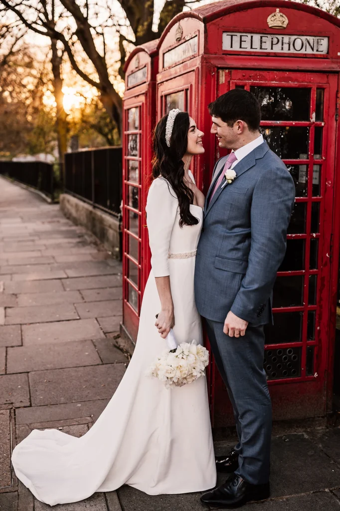 Romantic wedding couple portrait by iconic red London phone booth