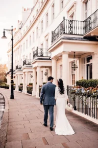 Wedding couple walking hand in hand through classic Belgravia architecture