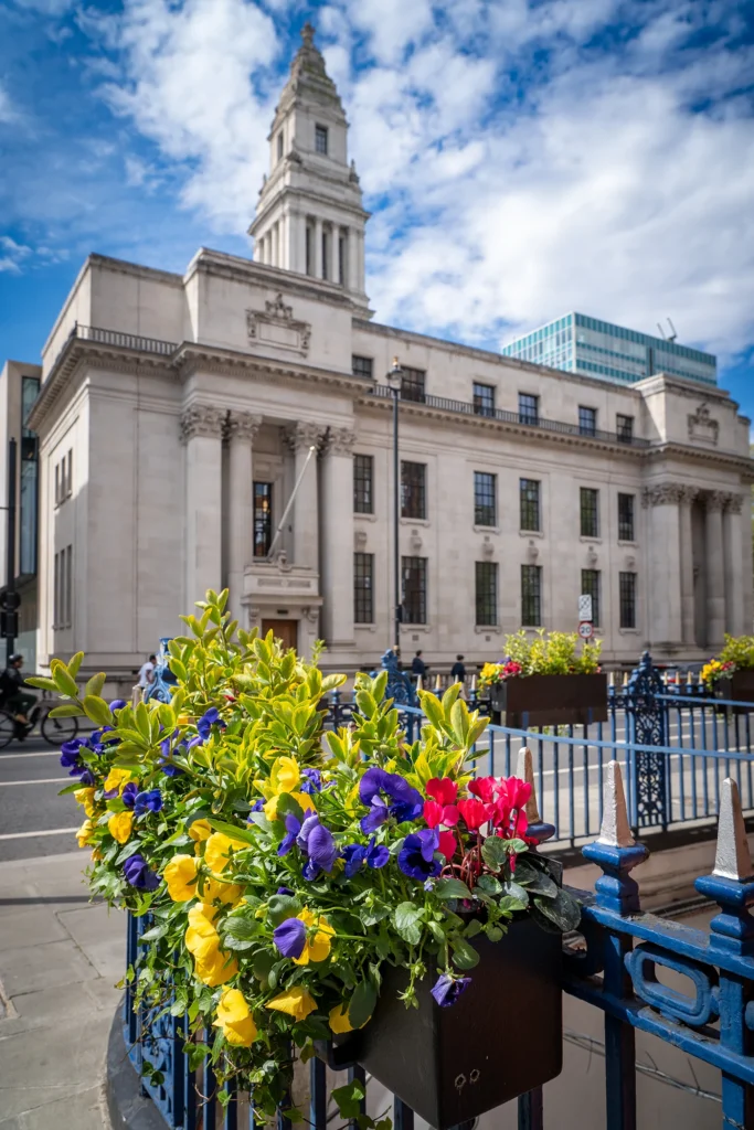 Exterior view of Marylebone Town Hall with colourful flowers on a sunny day