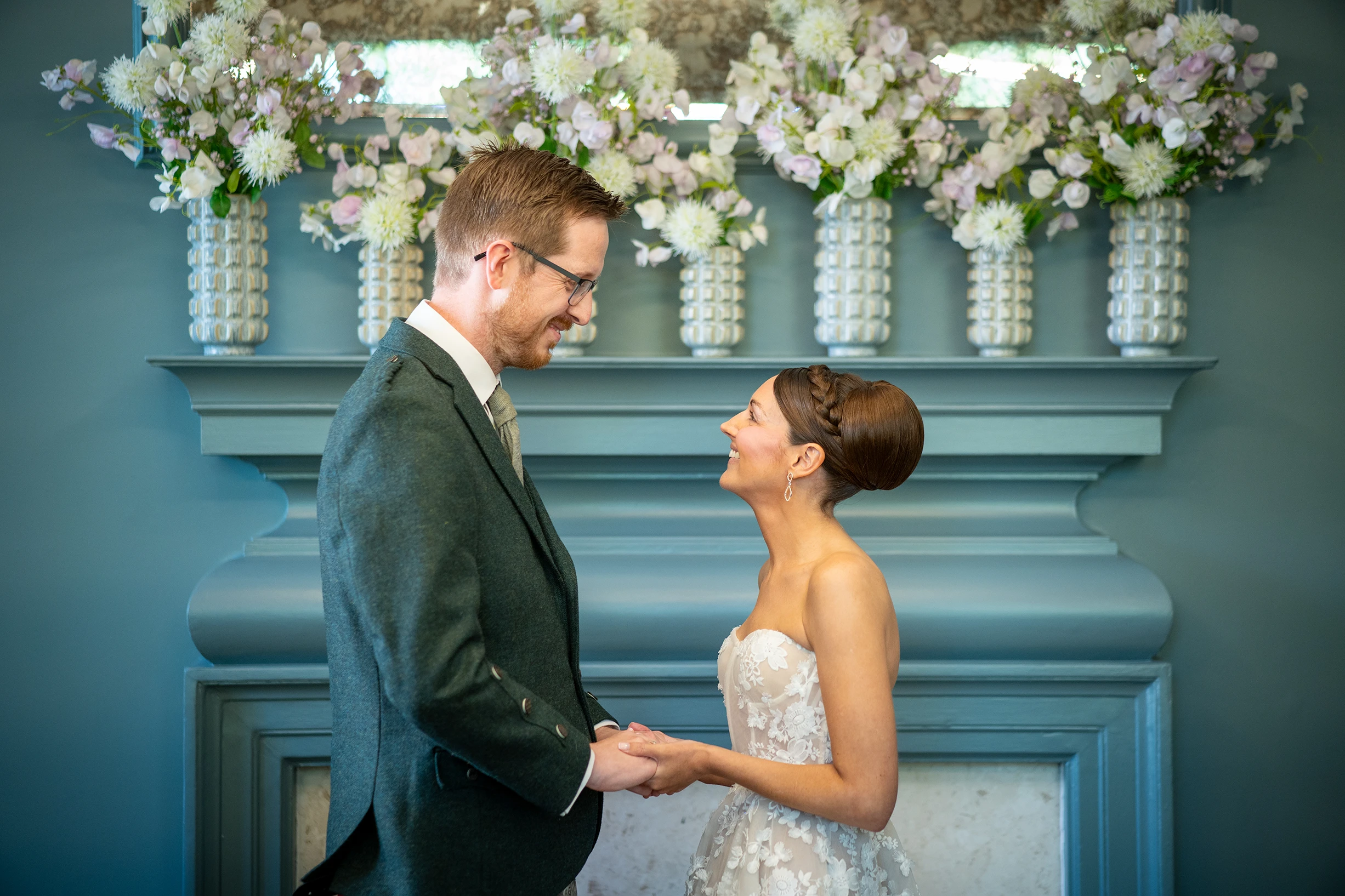 Couple sharing a loving moment in front of floral backdrop