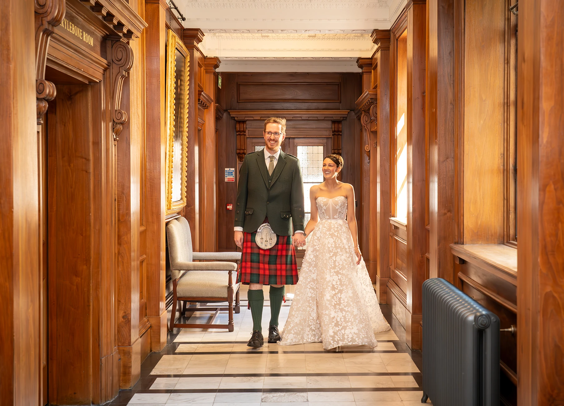 Bride and groom holding hands walking